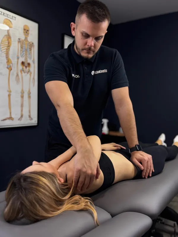 Fizjoterapeuta Karol Krawczyk podczas terapii manualnej – gabinet FizjoKinetic, Bemowo